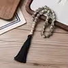 مسبحة أكريليك من 33 خرزة بنقوش حلزونية 10×10 مم – A53-33E4-3 — White — فاتح بنقوش رمادية كما في الصورة، مع شرابة سوداء