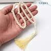 مسبحة أكريليك 99 حبة مسطحة 4×7.5 مم بشرابة — H52-99E4-1 — كريمي مع شرابة فاتحة — Beige