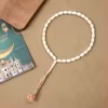 مسبحة أكريليك من 33 خرزة بيضاوية 10×13 مم بشرابة خيط – E3-33E1-2 — White-1 — أبيض مائل إلى العاجي مع شرابة فاتحة