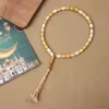 مسبحة أكريليك من 33 خرزة بيضاوية 10×13 مم بشرابة خيط – E3-33E1-2 — Gold — درجة بنية ذهبية اللون مع شرابة فاتحة
